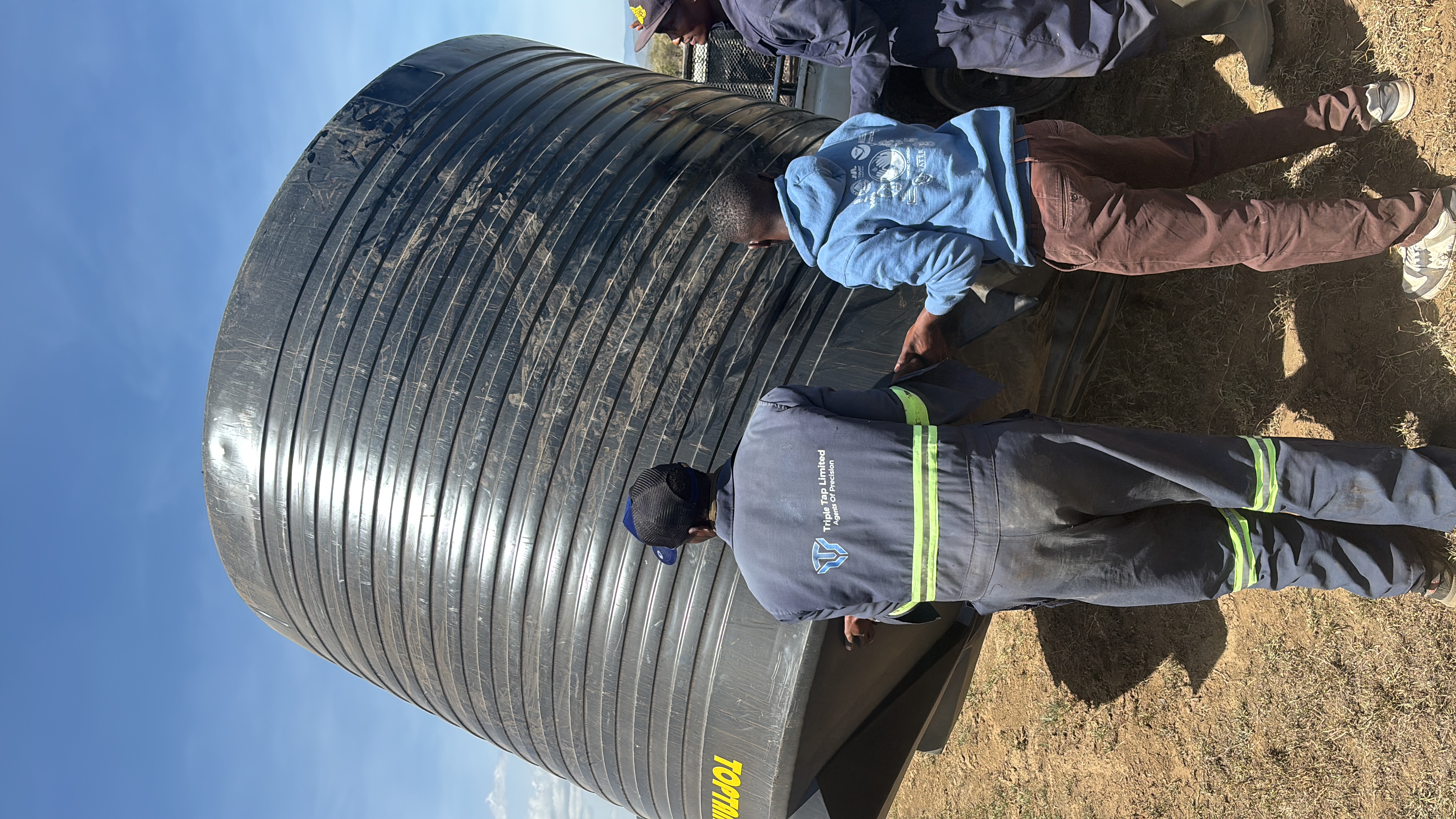 The farm team positioning a bulk water storage tank